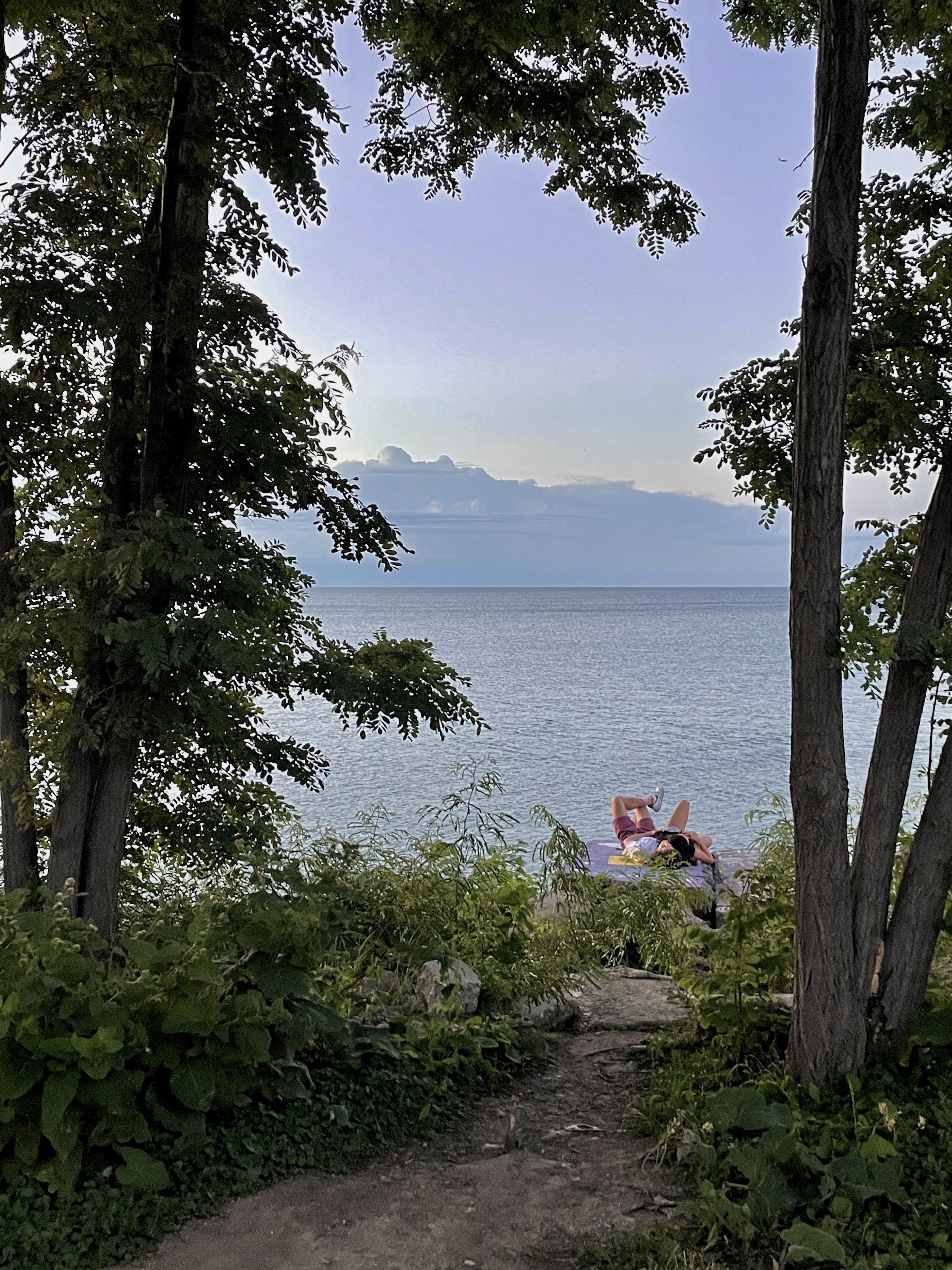 2 people laying on a rock